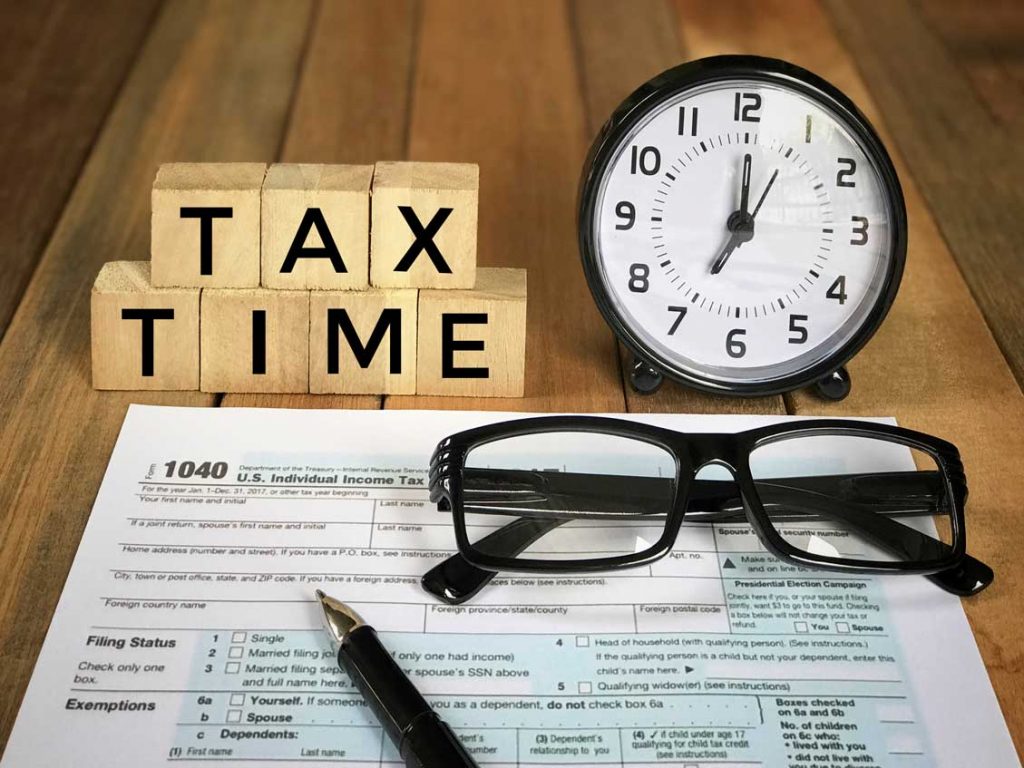Tax Time’ Words On Wooden Blocks, Pen, Eyeglasses, Featuring Half Of U